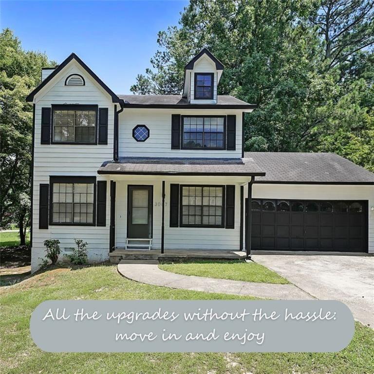 3087 Drexel Lane Rex, GA 30273 - Photo 9 of 22 a view of a white house with a large window and large tree