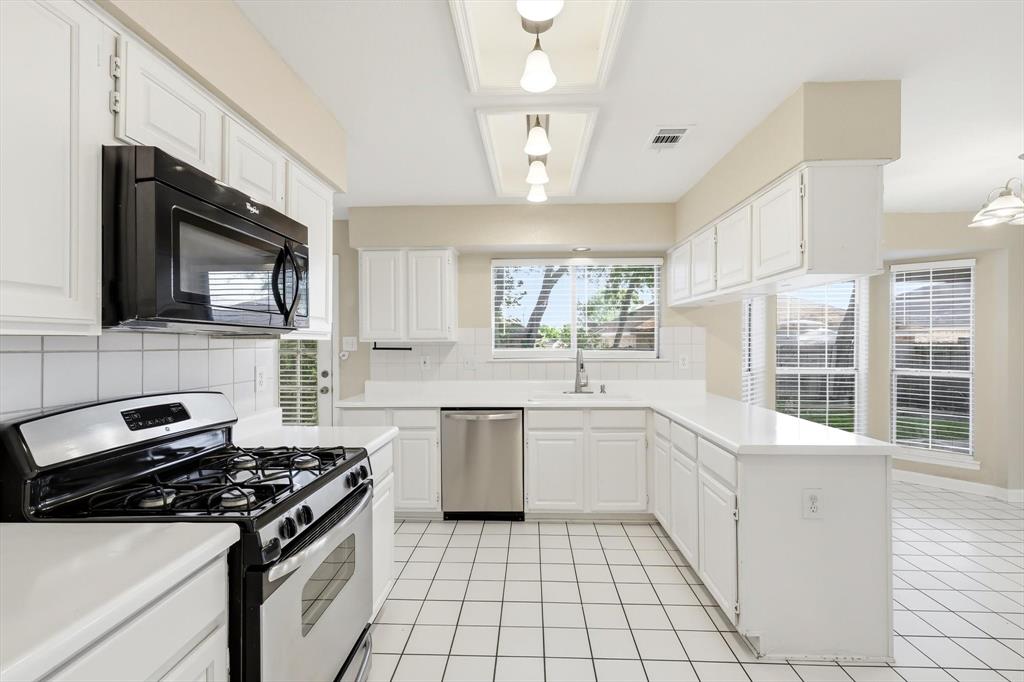 5512 Rocky Mountain Road Fort Worth, TX 76137 - Photo 12 of 33 a kitchen with a stove a sink and a microwave