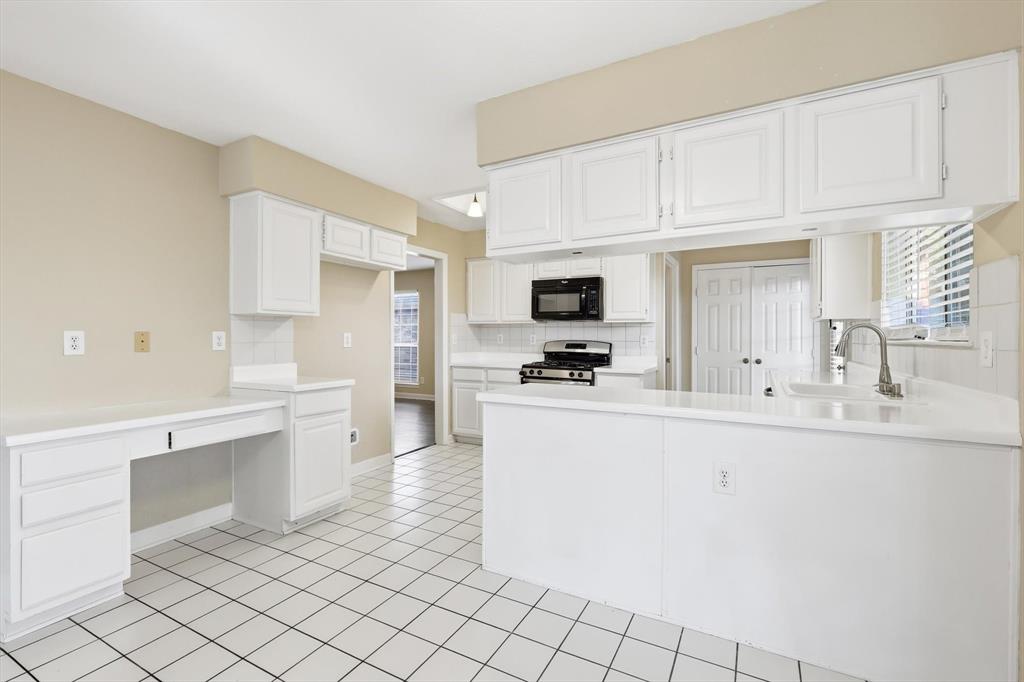 5512 Rocky Mountain Road Fort Worth, TX 76137 - Photo 15 of 33 a kitchen with white cabinets a sink and appliances