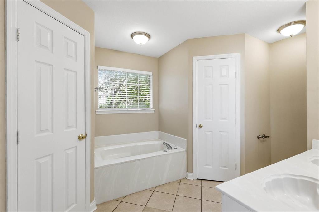 5512 Rocky Mountain Road Fort Worth, TX 76137 - Photo 20 of 33 a spacious bathroom with a bathtub and shower