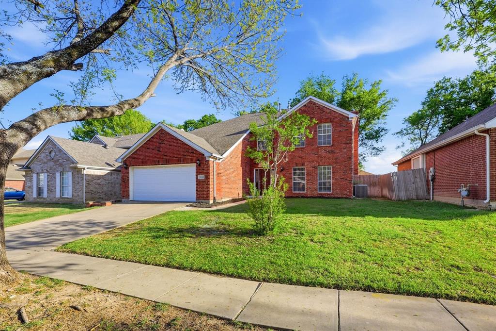 5512 Rocky Mountain Road Fort Worth, TX 76137 - Photo 2 of 33 a front view of a house with a yard and garage