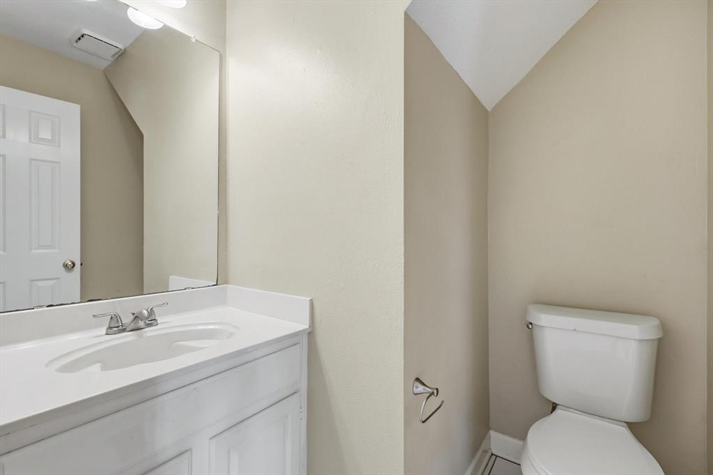 5512 Rocky Mountain Road Fort Worth, TX 76137 - Photo 25 of 33 a bathroom with a toilet sink and mirror