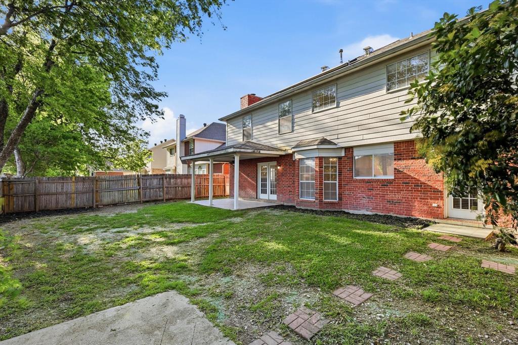 5512 Rocky Mountain Road Fort Worth, TX 76137 - Photo 32 of 33 a view of a house with a yard and deck