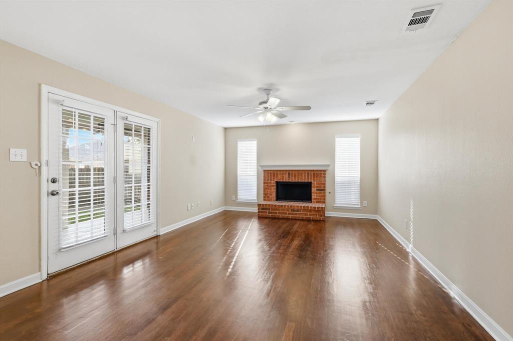 5512 Rocky Mountain Road Fort Worth, TX 76137 - Photo 9 of 33 a view of an empty room with wooden floor and a window