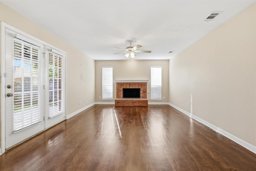5512 Rocky Mountain Road Fort Worth, TX 76137 - Photo 10 of 33 a view of an empty room with wooden floor and a window
