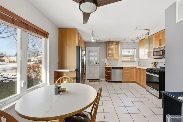 a kitchen with granite countertop a sink cabinets and stainless steel appliances