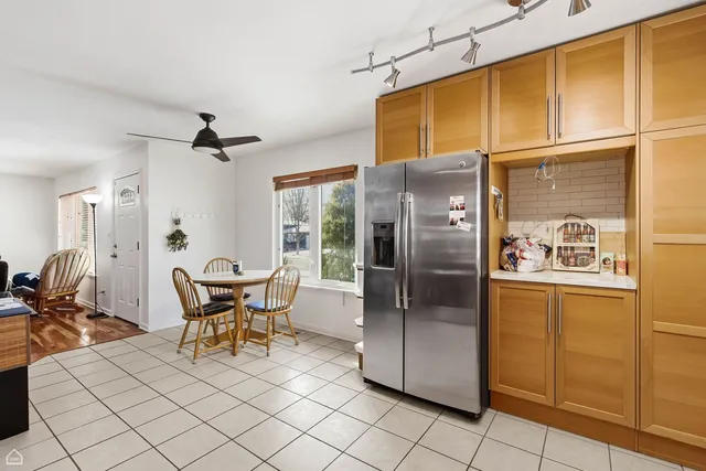 a kitchen with stainless steel appliances granite countertop a refrigerator and a sink