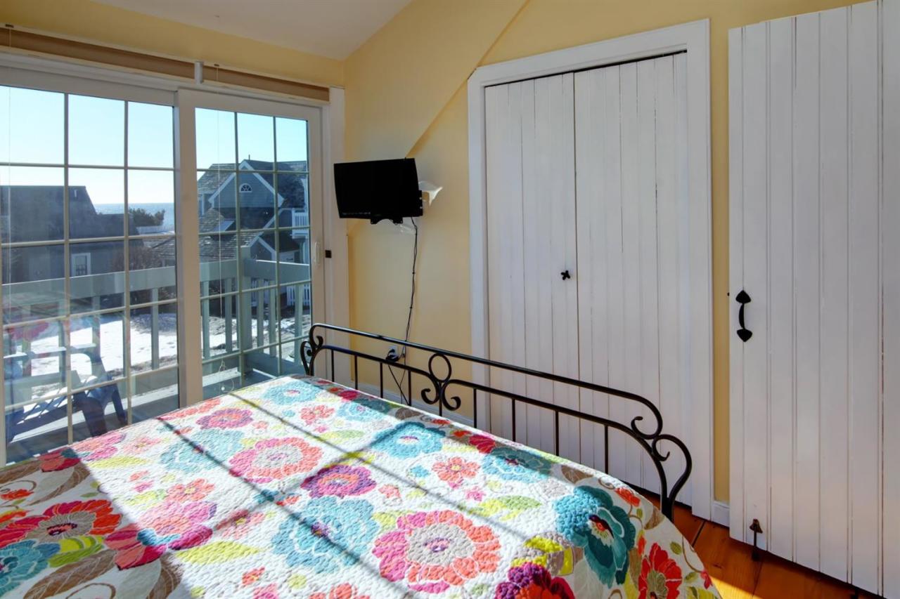 9 Hammock Pond Road Mashpee, MA 02649 - Photo 13 of 16 a bedroom with a bed a flat screen tv and a dresser