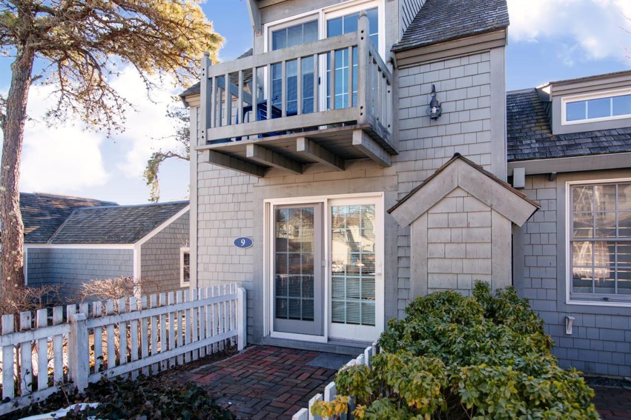 9 Hammock Pond Road Mashpee, MA 02649 - Photo 2 of 16 a view of a house with a small yard and plants