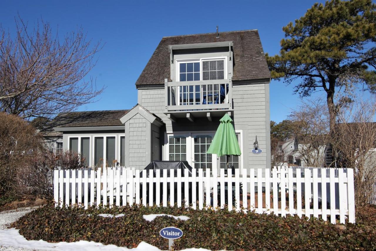 9 Hammock Pond Road Mashpee, MA 02649 - Photo 3 of 16 a front view of a house with a garden