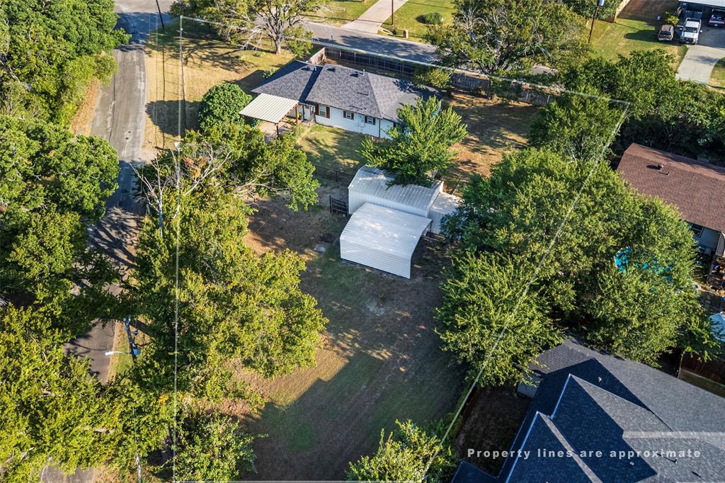 310 North Road Kennedale, TX 76060 - Photo 21 of 23 Single-story residence with a gabled roof and attached carport