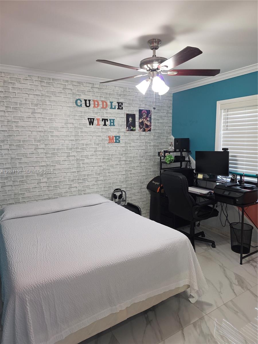 651 East 48th Street Hialeah, FL 33013 - Photo 8 of 52 a bedroom with a bed and a chandelier