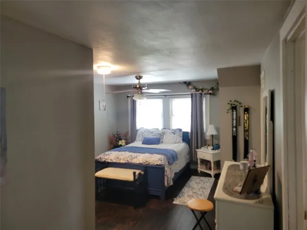 a bedroom with a bed and a chair