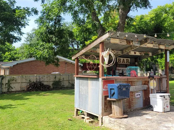 a view of a patio with table and chairs under an umbrella