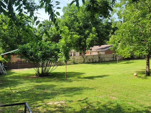 a view of a backyard with swimming pool