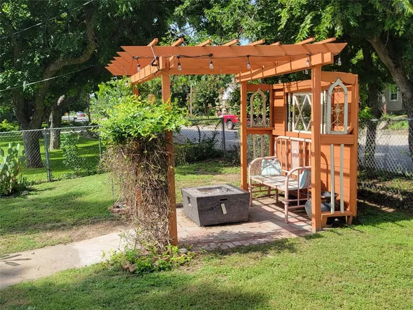 a backyard of a house with yard and outdoor seating