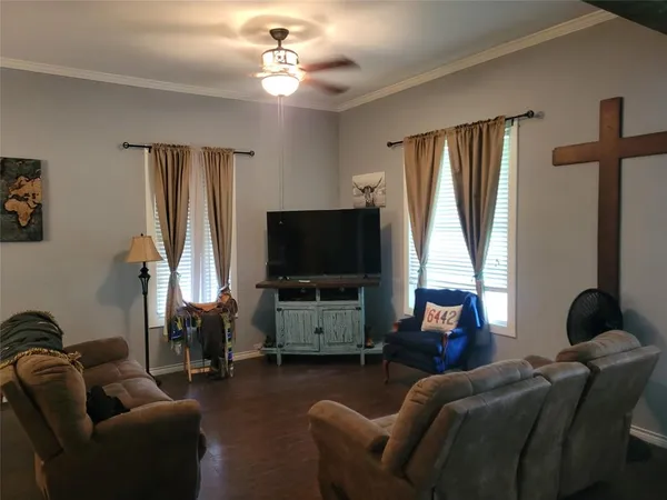 a living room with furniture and a flat screen tv