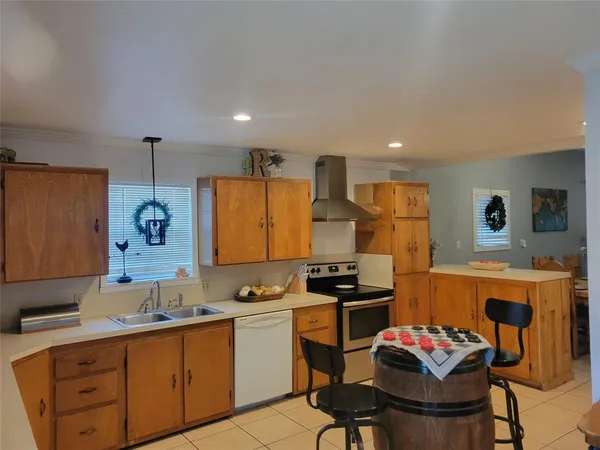 a kitchen with stainless steel appliances kitchen island granite countertop a sink and cabinets