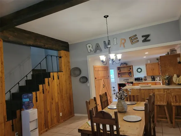 a view of a dining room with furniture and chandelier