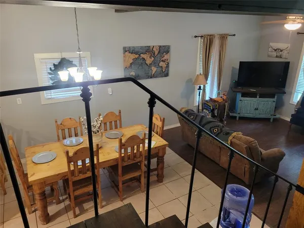 a view of a dining room with furniture and a flat screen tv