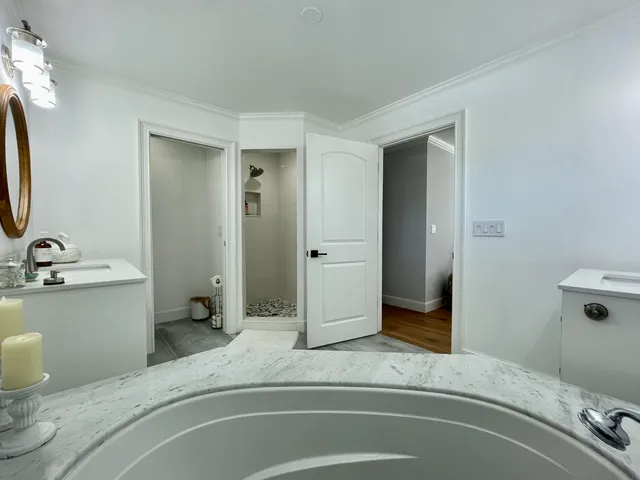 a en suite bathroom with a double vanity sink and a mirror