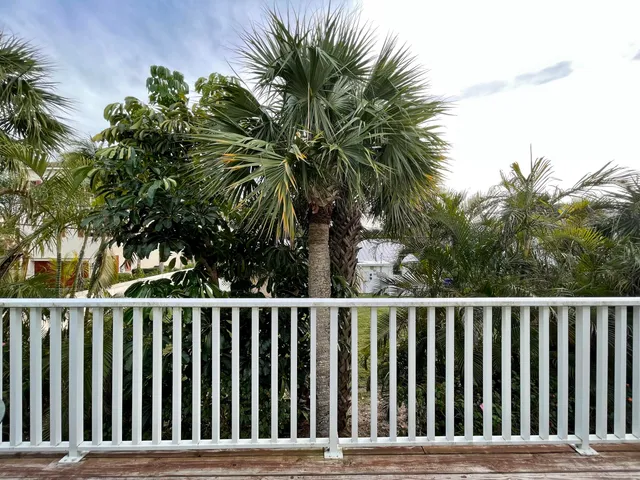 a view of balcony with wooden floor and outdoor seating