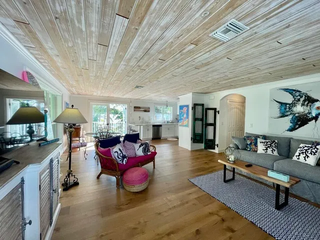 a palm tree sitting in front of a house with a yard