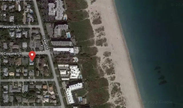 a view of an ocean beach and mountain