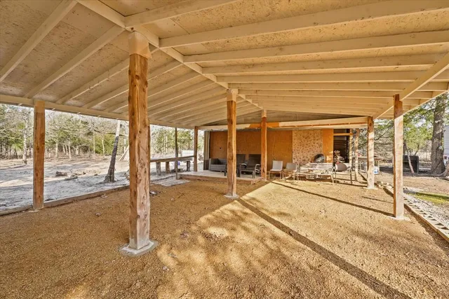 a backyard of a house with table and chairs