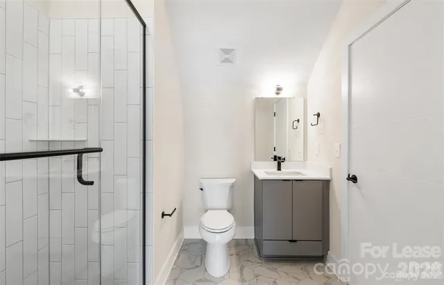 a bathroom with a toilet a sink and shower