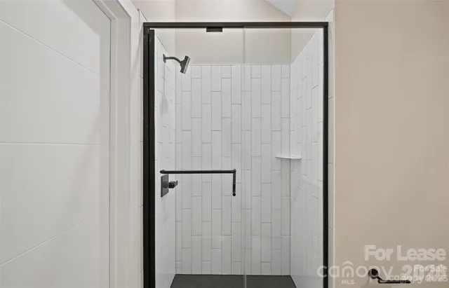 a bathroom with a glass shower door