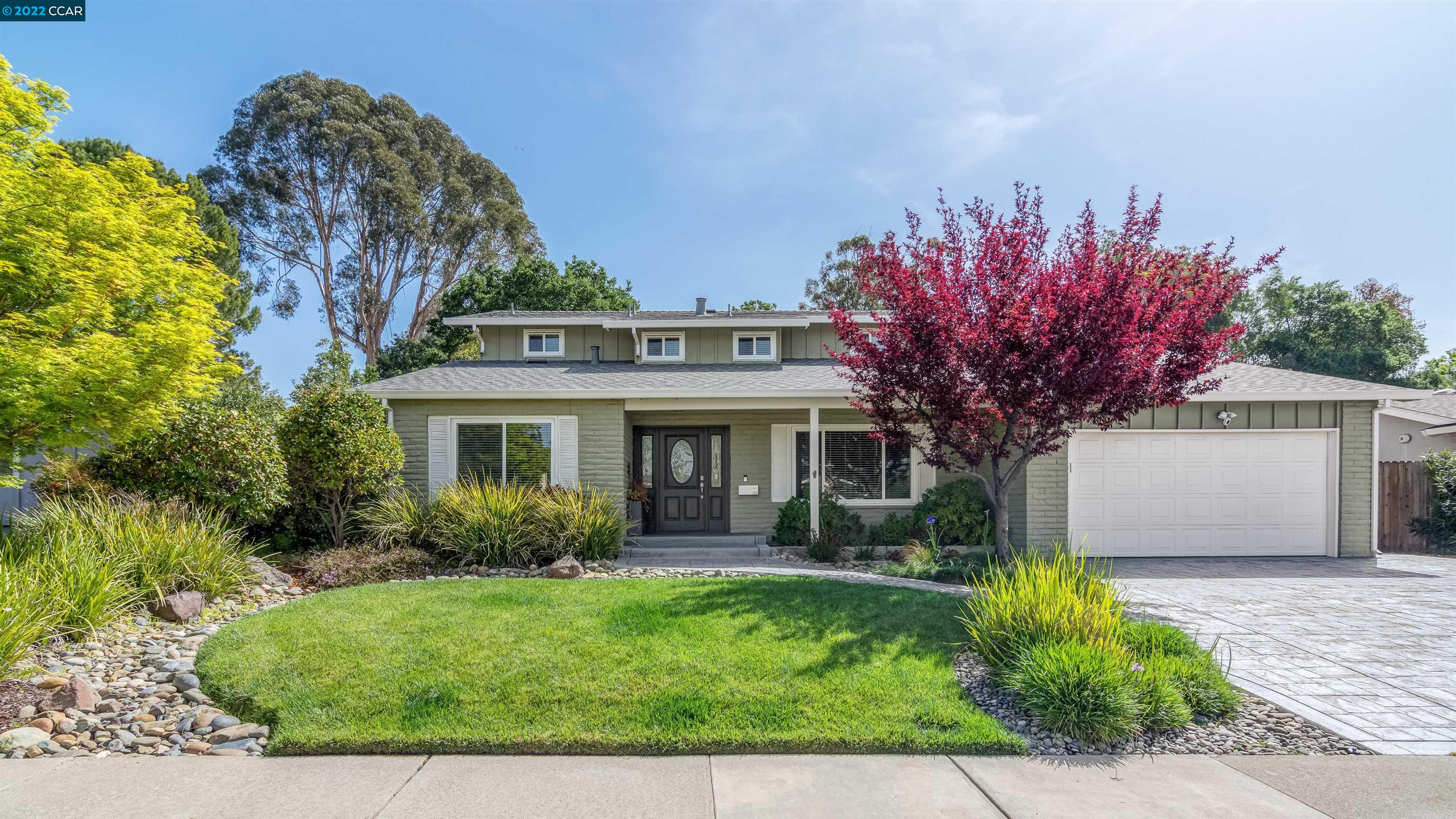 a front view of a house with garden