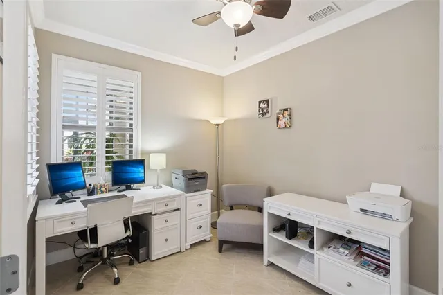 a view of a workspace with furniture and a window