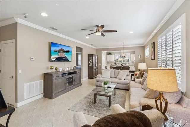 a living room with furniture a flat screen tv and a window