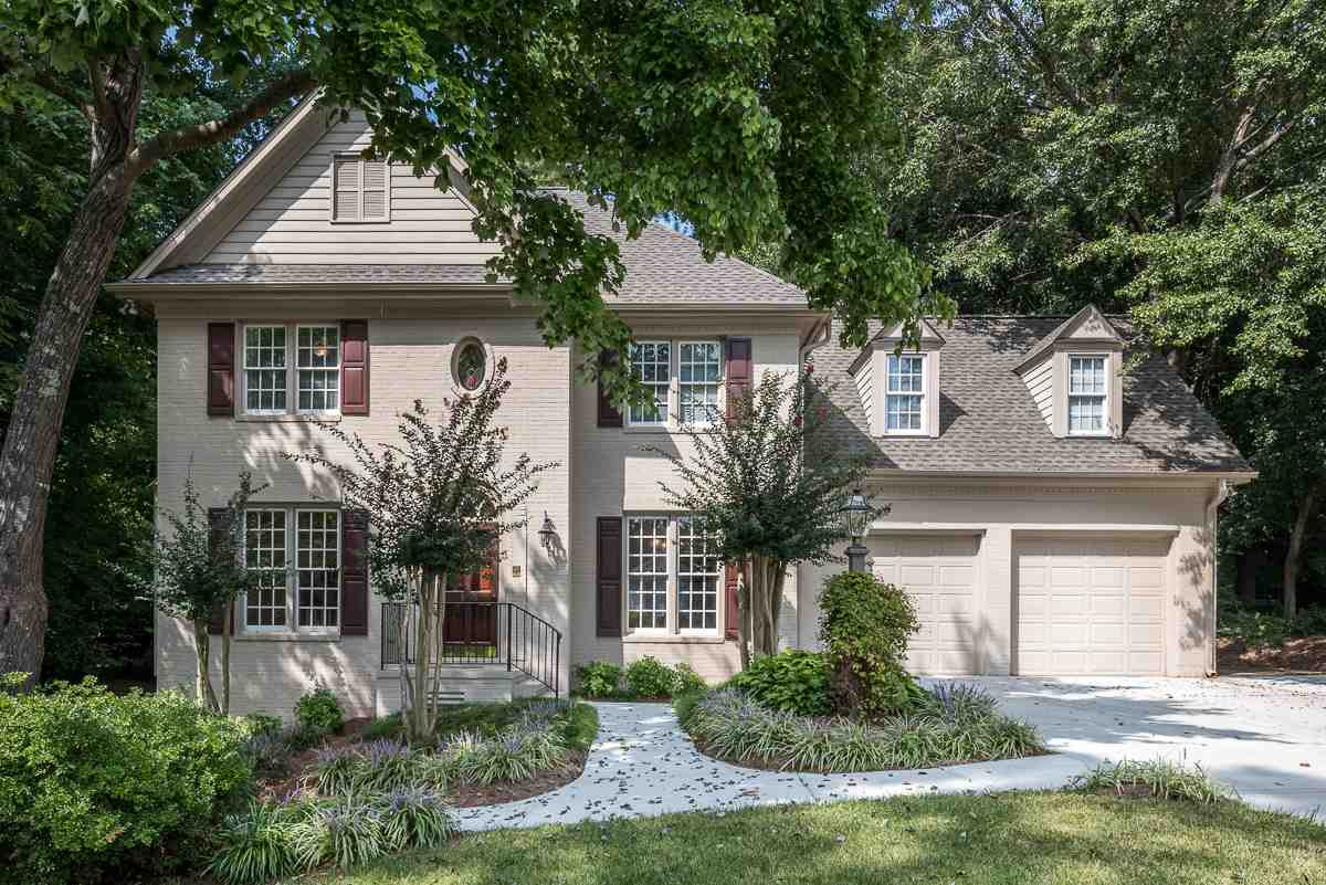 Beautiful Painted Brick Front 2 Story with Accent Window, Dormers, Wrought Iron Railing, Post Lamp, Two Car Garage, New Driveway & Parking Pad. Exterior Front