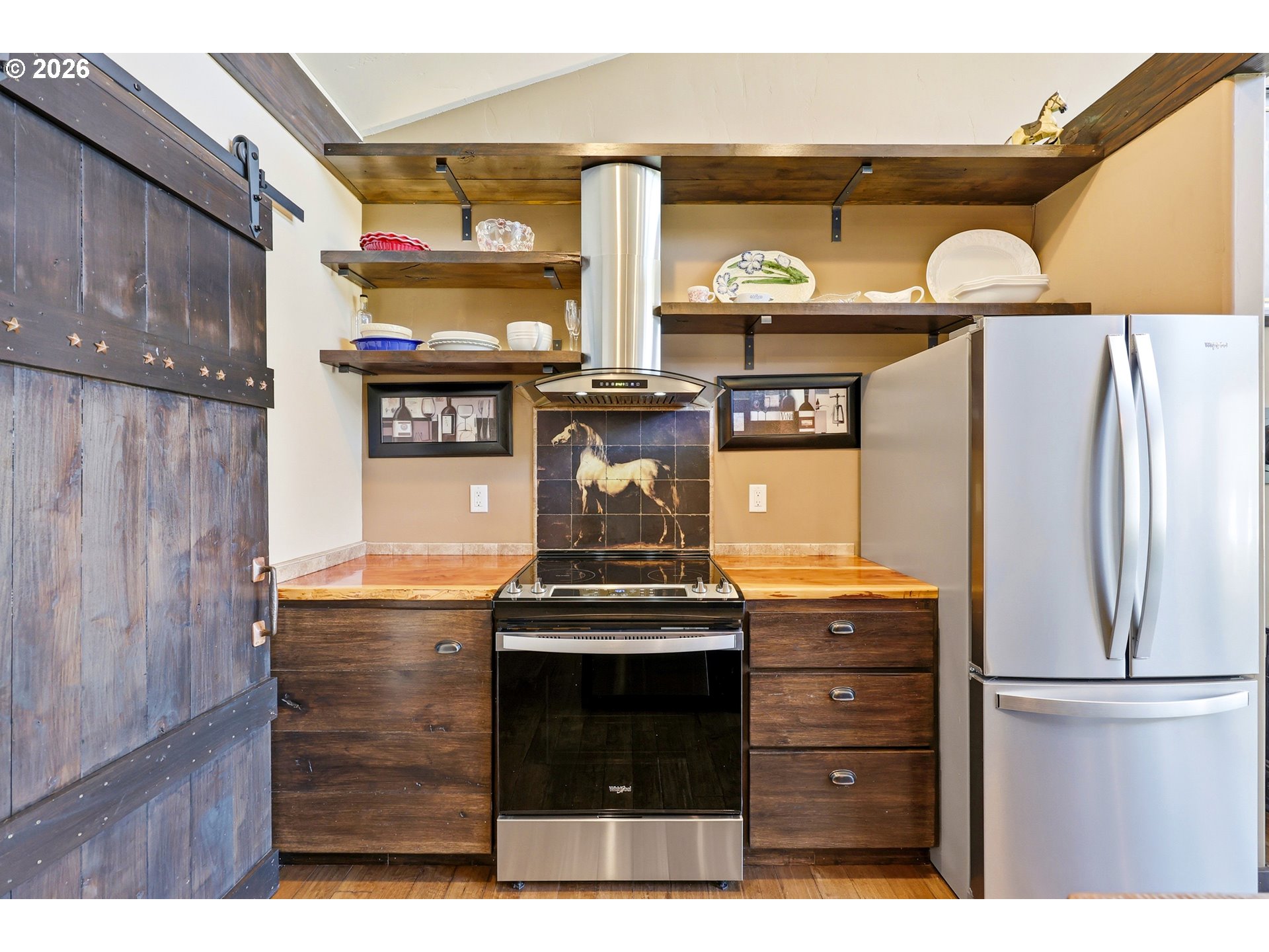 206 South Lakewood Road Tygh Valley, OR 97063 - Photo 12 of 48 a kitchen with stainless steel appliances granite countertop a stove and a refrigerator