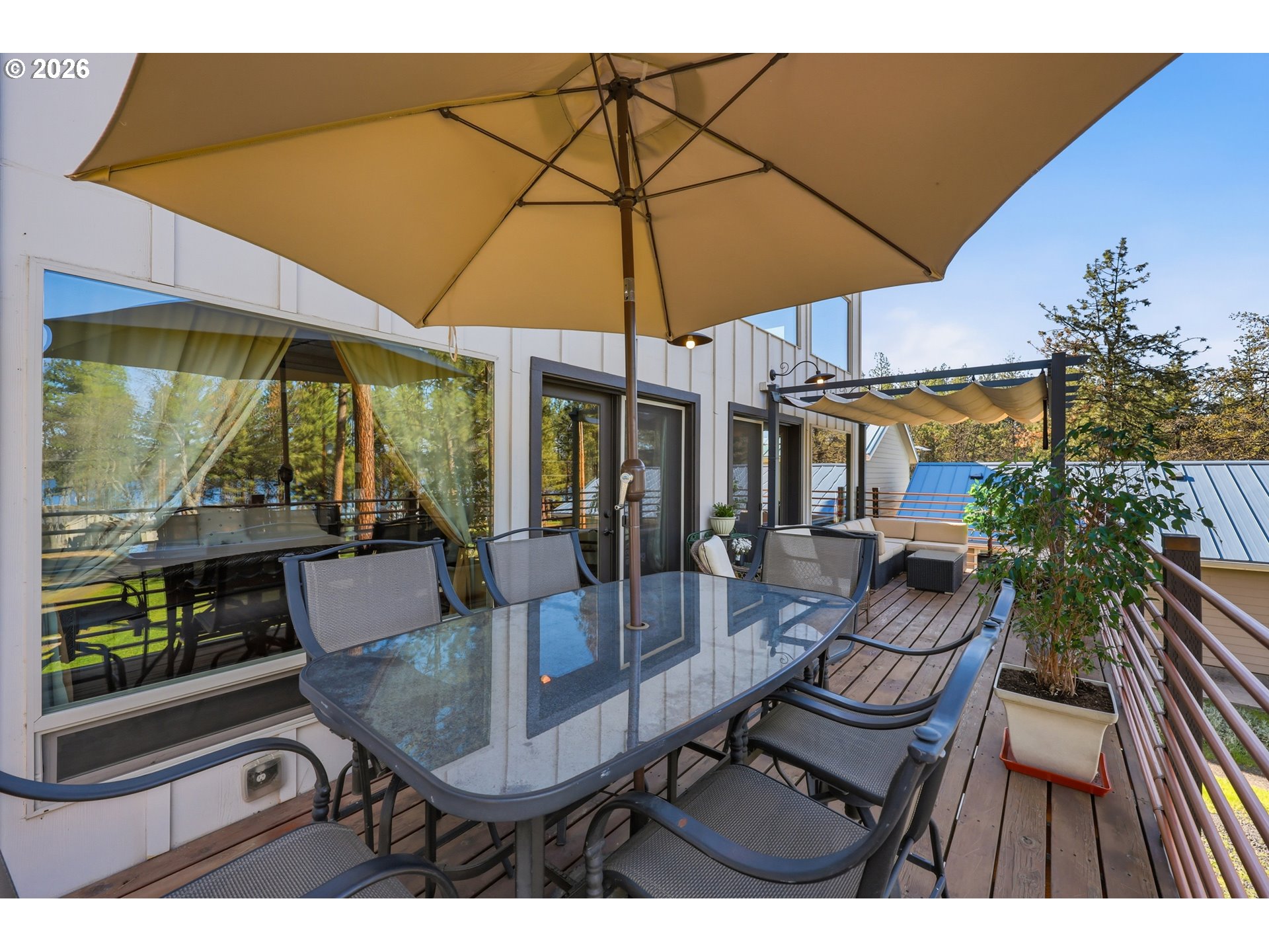 206 South Lakewood Road Tygh Valley, OR 97063 - Photo 33 of 48 a view of a patio with table and chairs under an umbrella