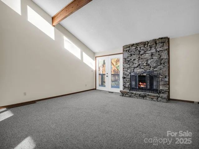 a view of empty room with a fireplace