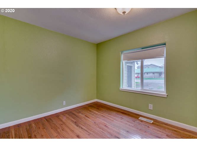 500 Toliver Road Molalla, OR 97038 - Photo 11 of 25 an empty room with wooden floor and windows