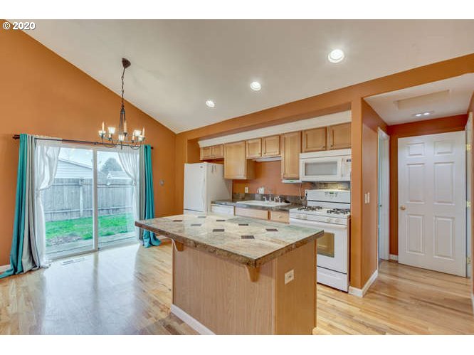 500 Toliver Road Molalla, OR 97038 - Photo 12 of 25 a kitchen that has a kitchen island wooden cabinets and stainless steel appliances