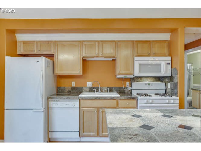 500 Toliver Road Molalla, OR 97038 - Photo 17 of 25 a kitchen with stainless steel appliances granite countertop a refrigerator a stove and a sink with wooden floor