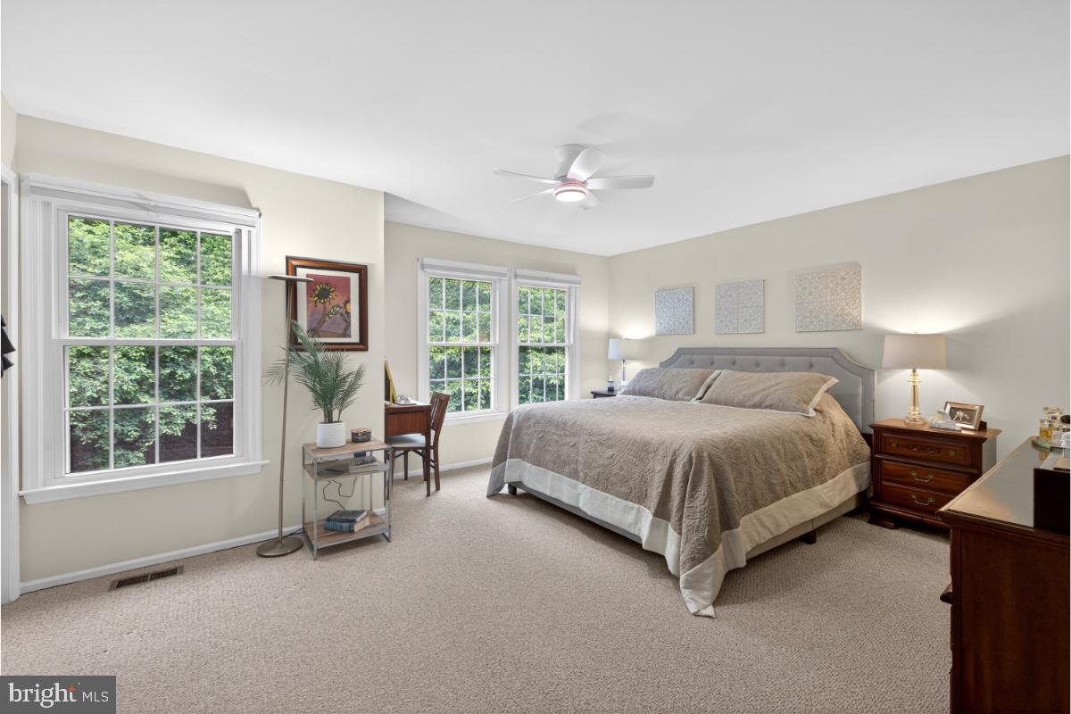 7347 Swan Point Way, Unit 122 Columbia, MD 21045 - Photo 5 of 54 a spacious bedroom with a bed and a window