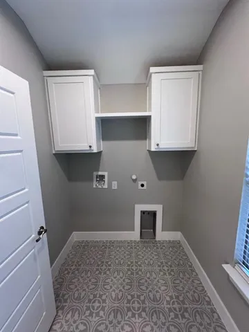a view of storage and utility room with closet