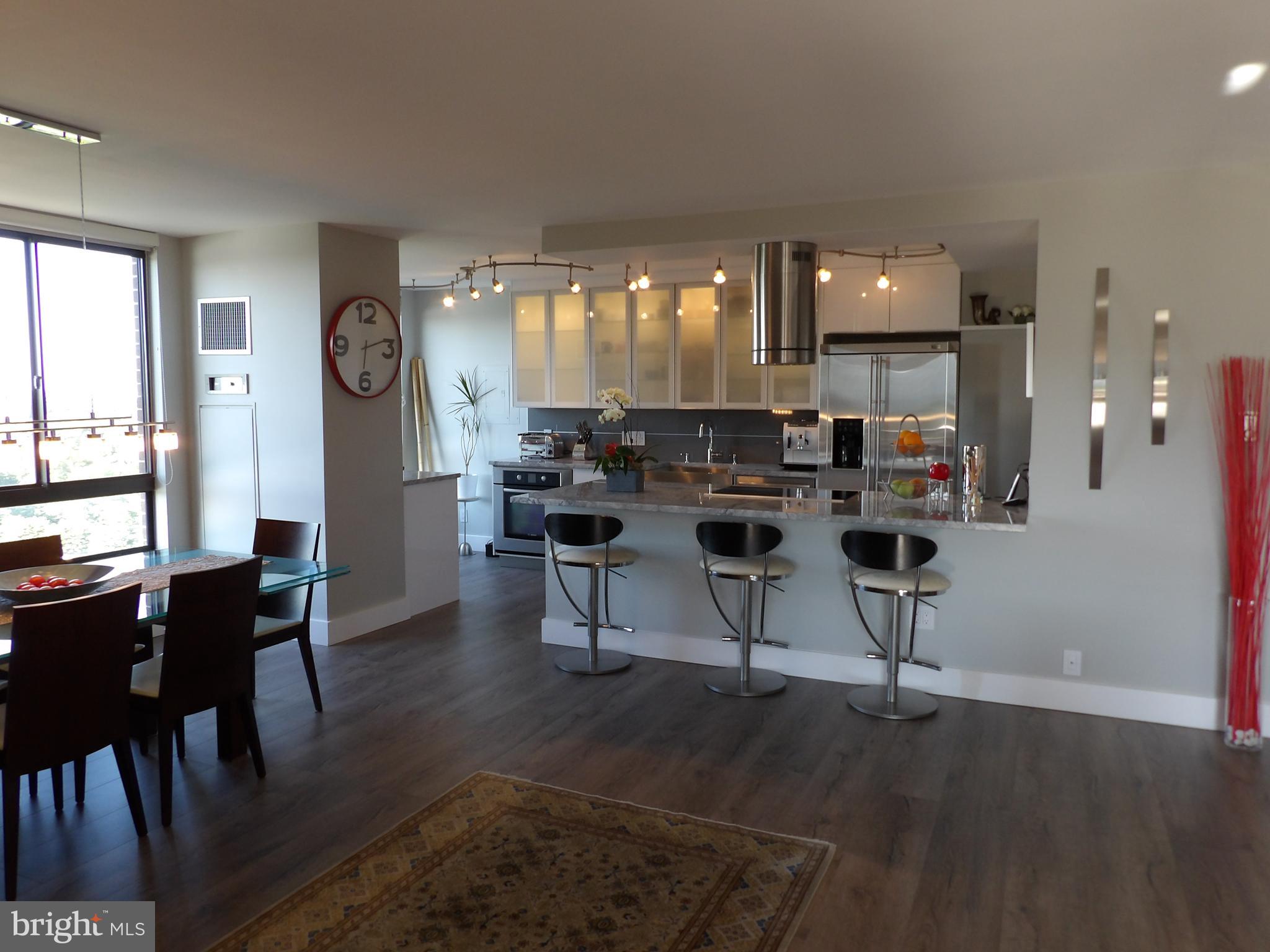 1800 Old Meadow Road, Unit 902 McLean, VA 22102 - Photo 1 of 67 a view of a dining room with furniture and wooden floor