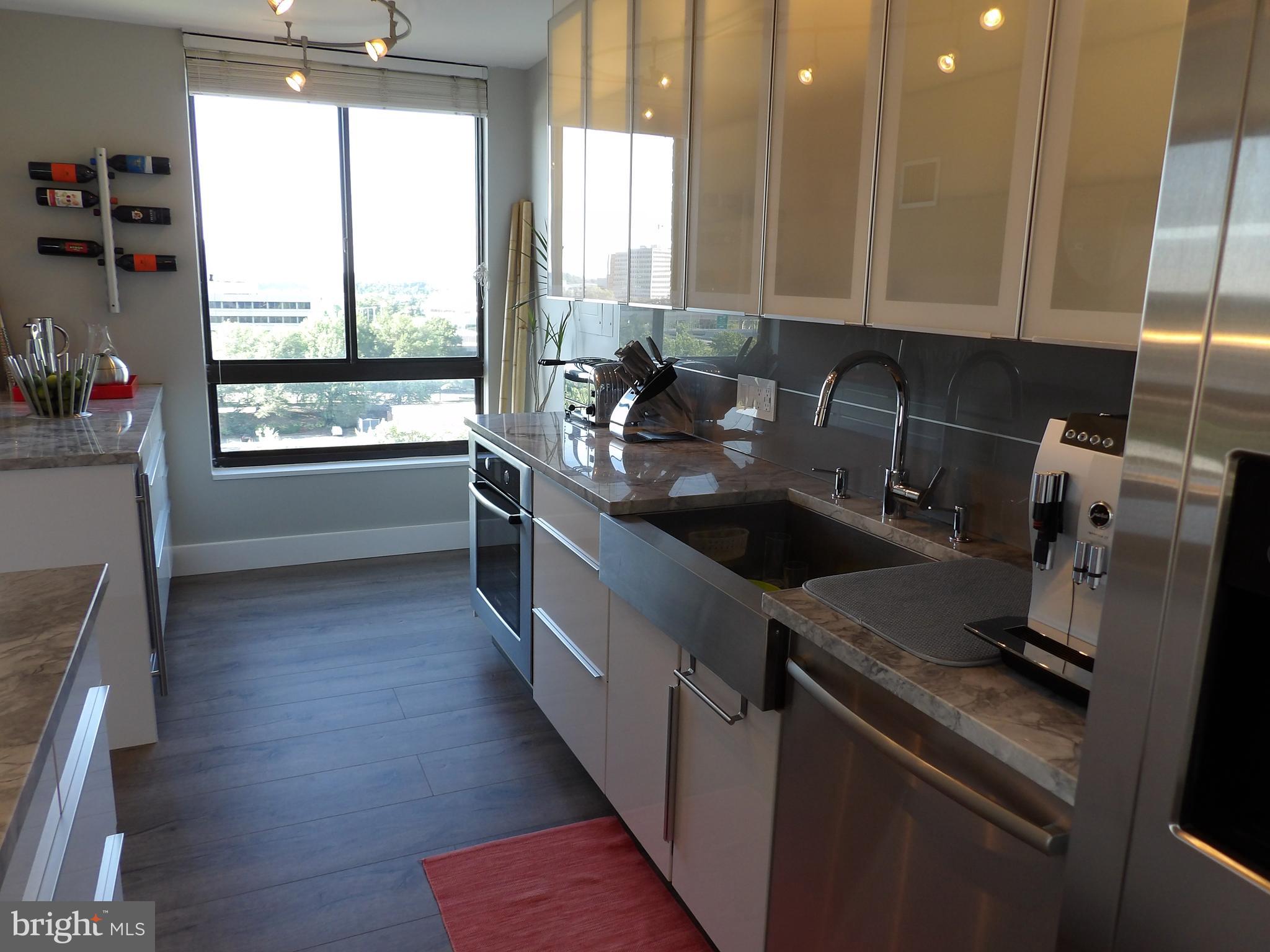 1800 Old Meadow Road, Unit 902 McLean, VA 22102 - Photo 12 of 67 a kitchen with a sink a counter top space and appliances