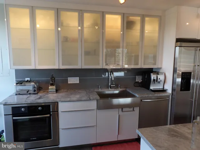 a kitchen with sink stove and refrigerator