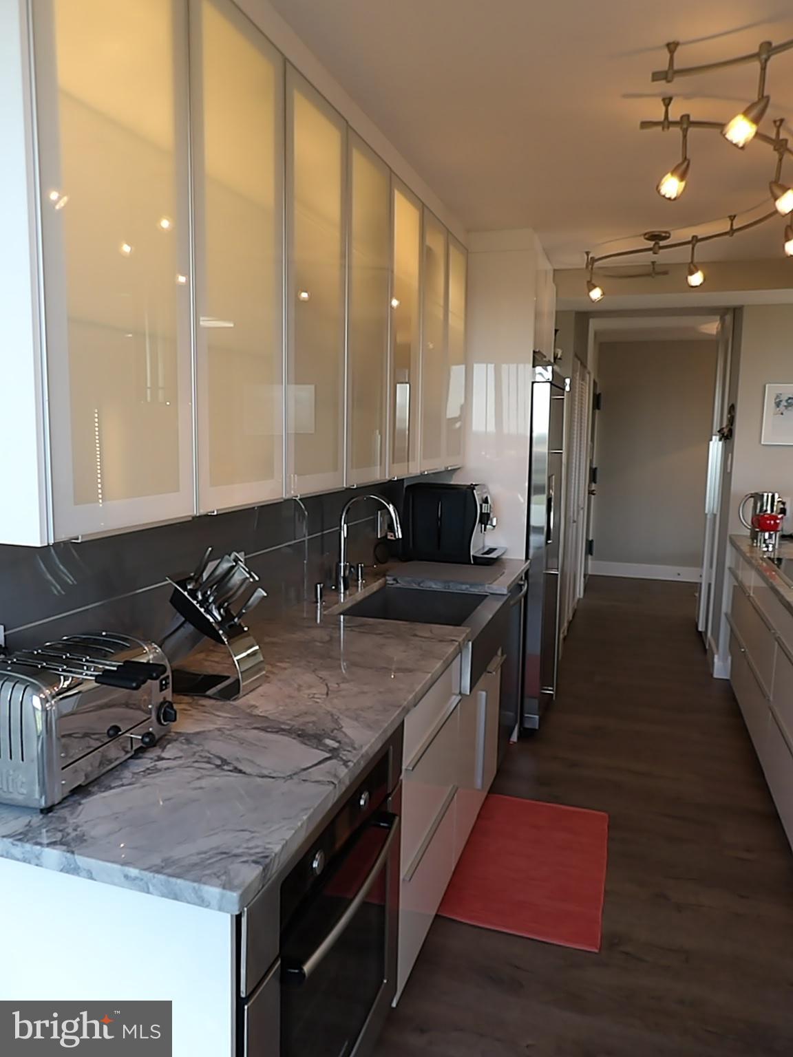 1800 Old Meadow Road, Unit 902 McLean, VA 22102 - Photo 18 of 67 a kitchen with sink stove and refrigerator