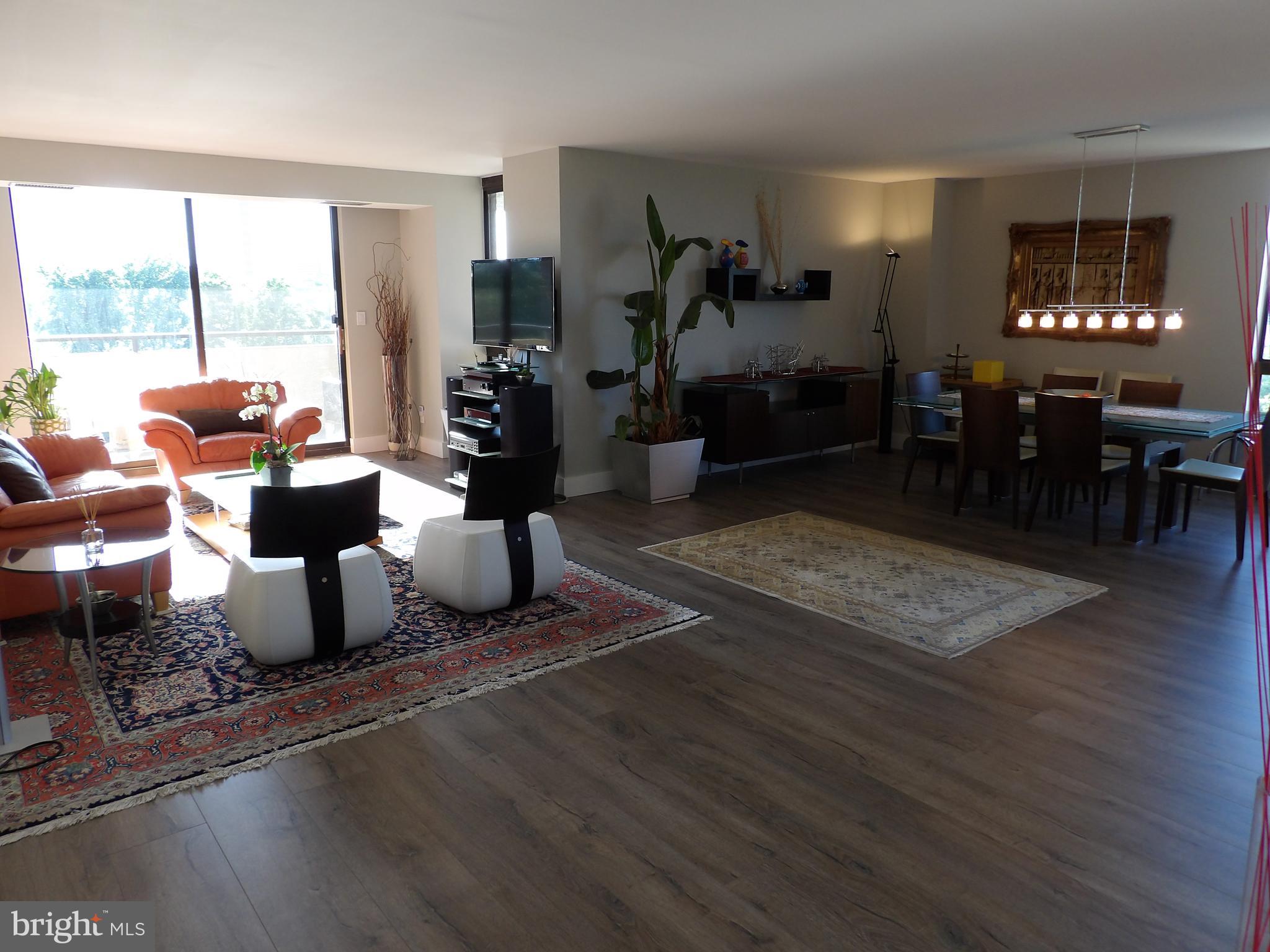 1800 Old Meadow Road, Unit 902 McLean, VA 22102 - Photo 22 of 67 a living room with furniture large window and wooden floor
