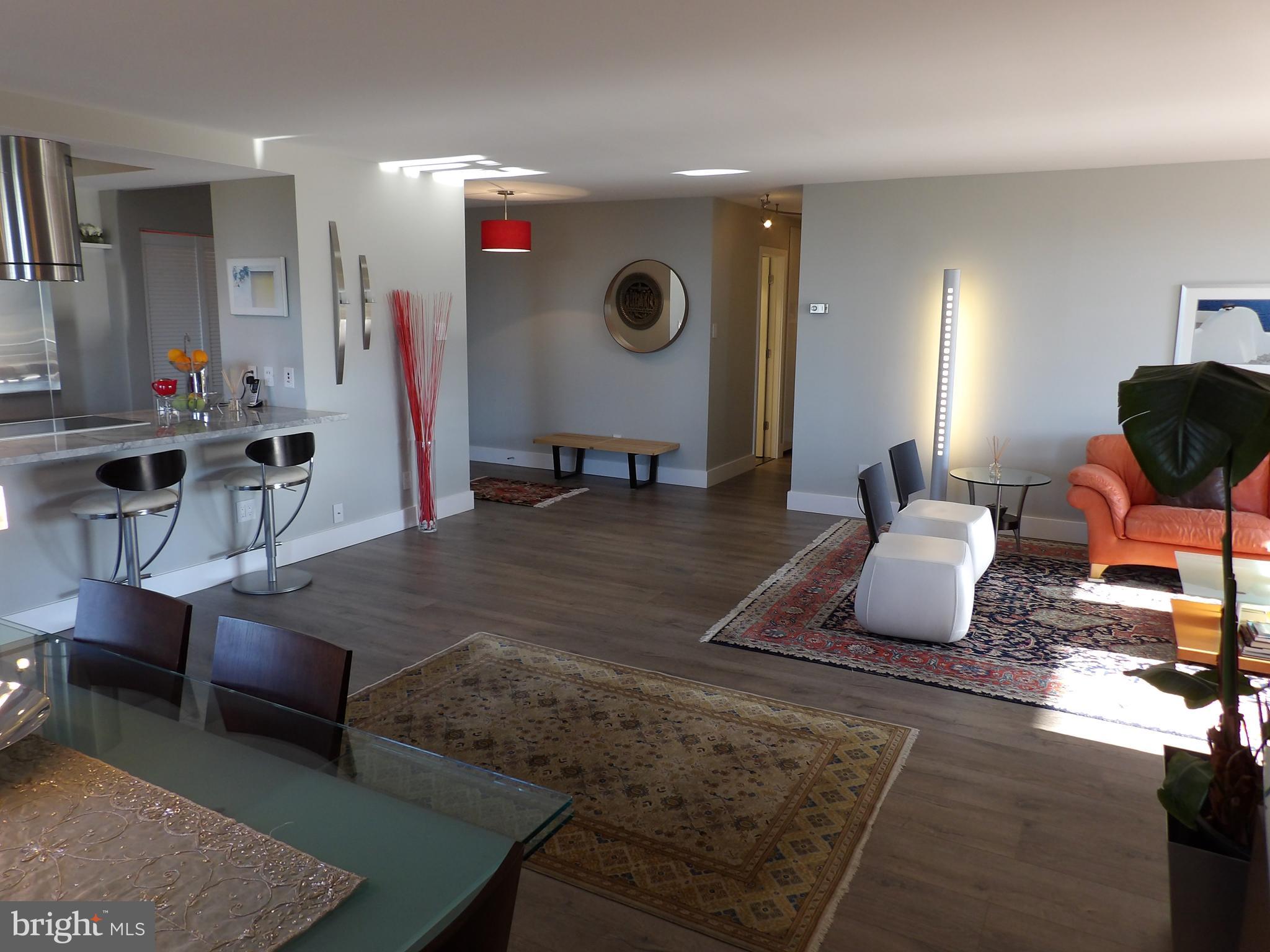 1800 Old Meadow Road, Unit 902 McLean, VA 22102 - Photo 26 of 67 a living room with furniture and a flat screen tv