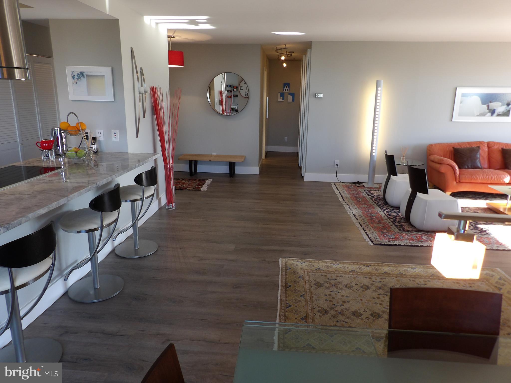 1800 Old Meadow Road, Unit 902 McLean, VA 22102 - Photo 28 of 67 a living room with furniture and a flat screen tv